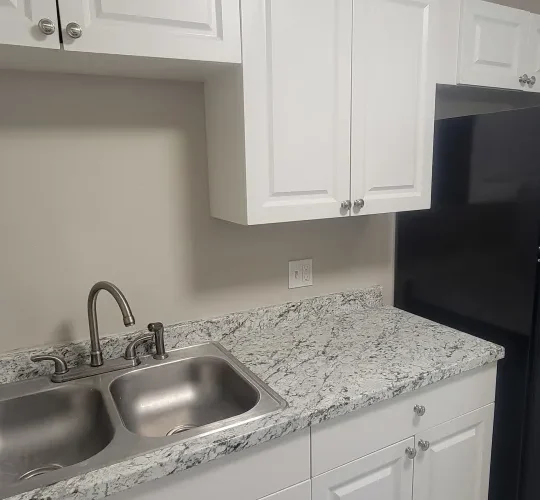 a kitchen with a sink, refrigerator and stove at The  Element At 464